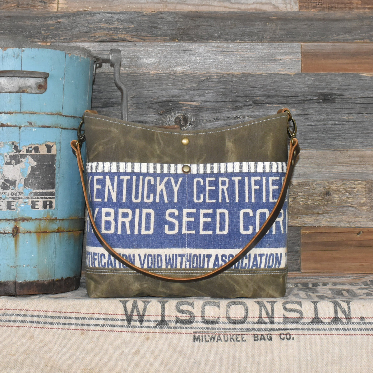 Handmade shoulder bag made from vintage Berea Kentucky Hybrid Corn Seed sack and army green waxed canvas. Includes genuine leather shoulder strap.